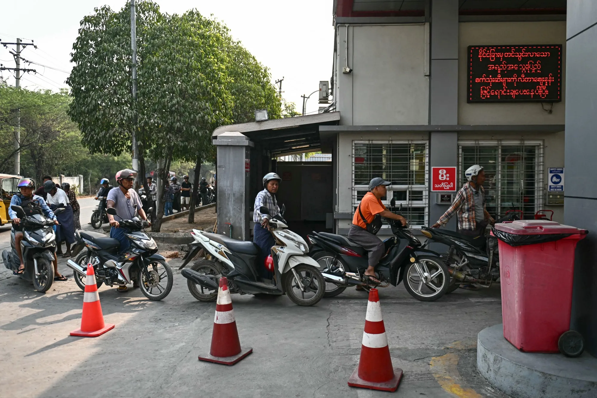 Motorists queue up at a petrol station amid rising fuel prices in Mandalay, Myanmar, on March 20.