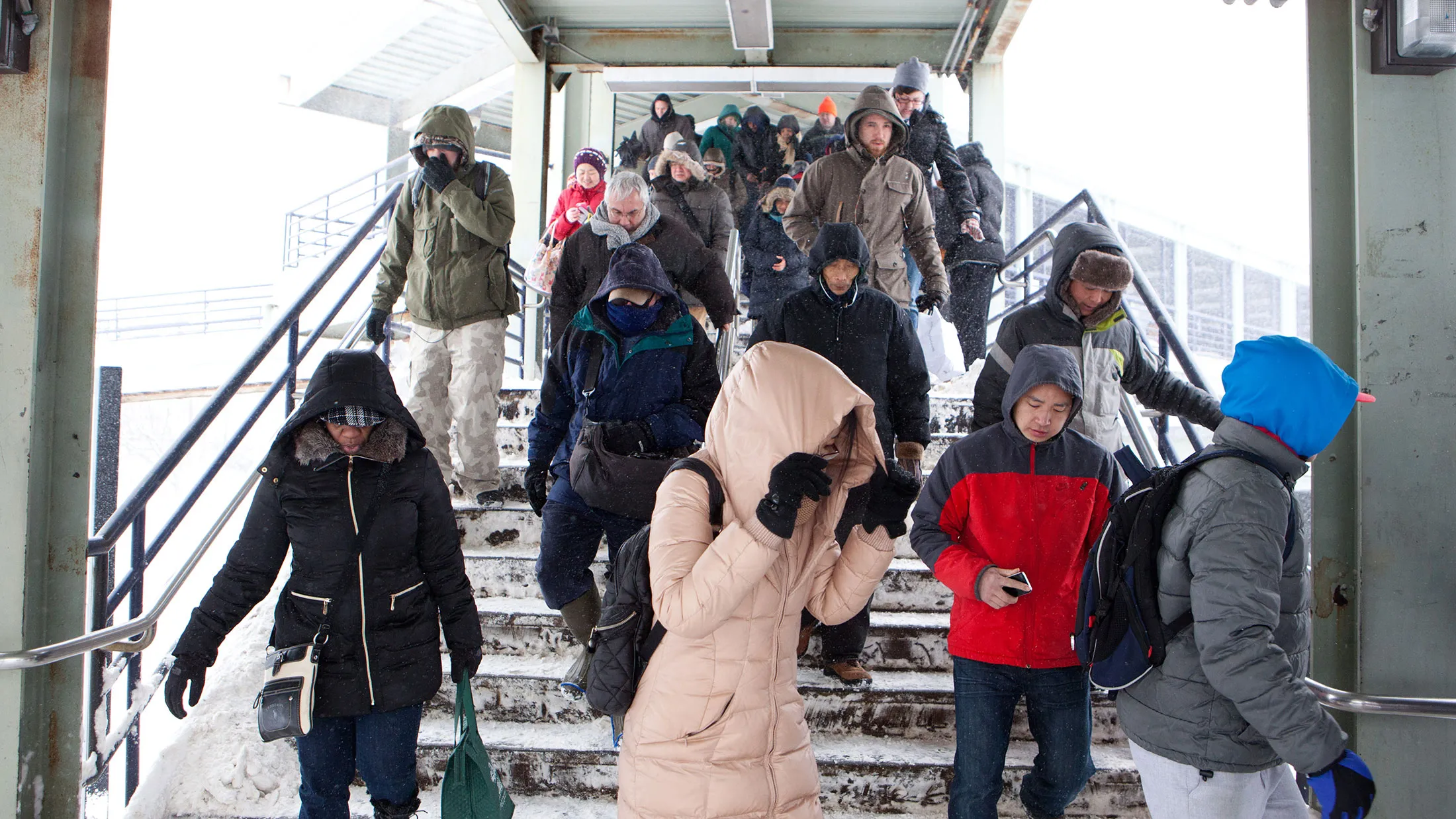 Commuters exit the Massachusetts Bay Transportation Authority's (MBTA) JFK/UMass station and head toward shuttle buses that carried them to their destinations on February 9, 2015, in Boston, Massachusetts.
