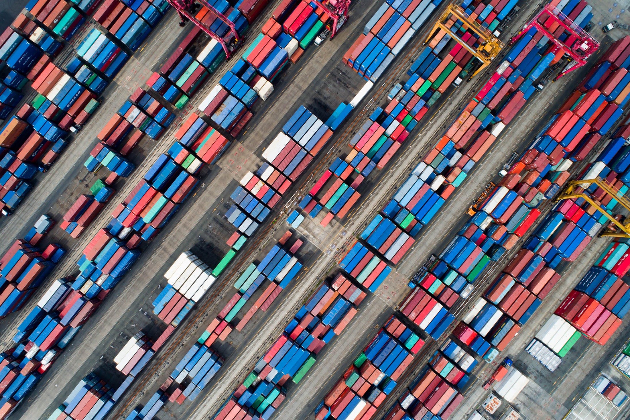 Shipping containers sit stacked in this aerial photograph taken above the Busan Port Terminal (BPT) in Busan, South Korea, on Monday, July 17, 2017. South Korea's exports will continue to rise in July and the third quarter as global trade continues to recover and unit costs rise, especially in sectors including semiconductors, vessels, petroleum goods and steel, according to a statement from the trade ministry.
