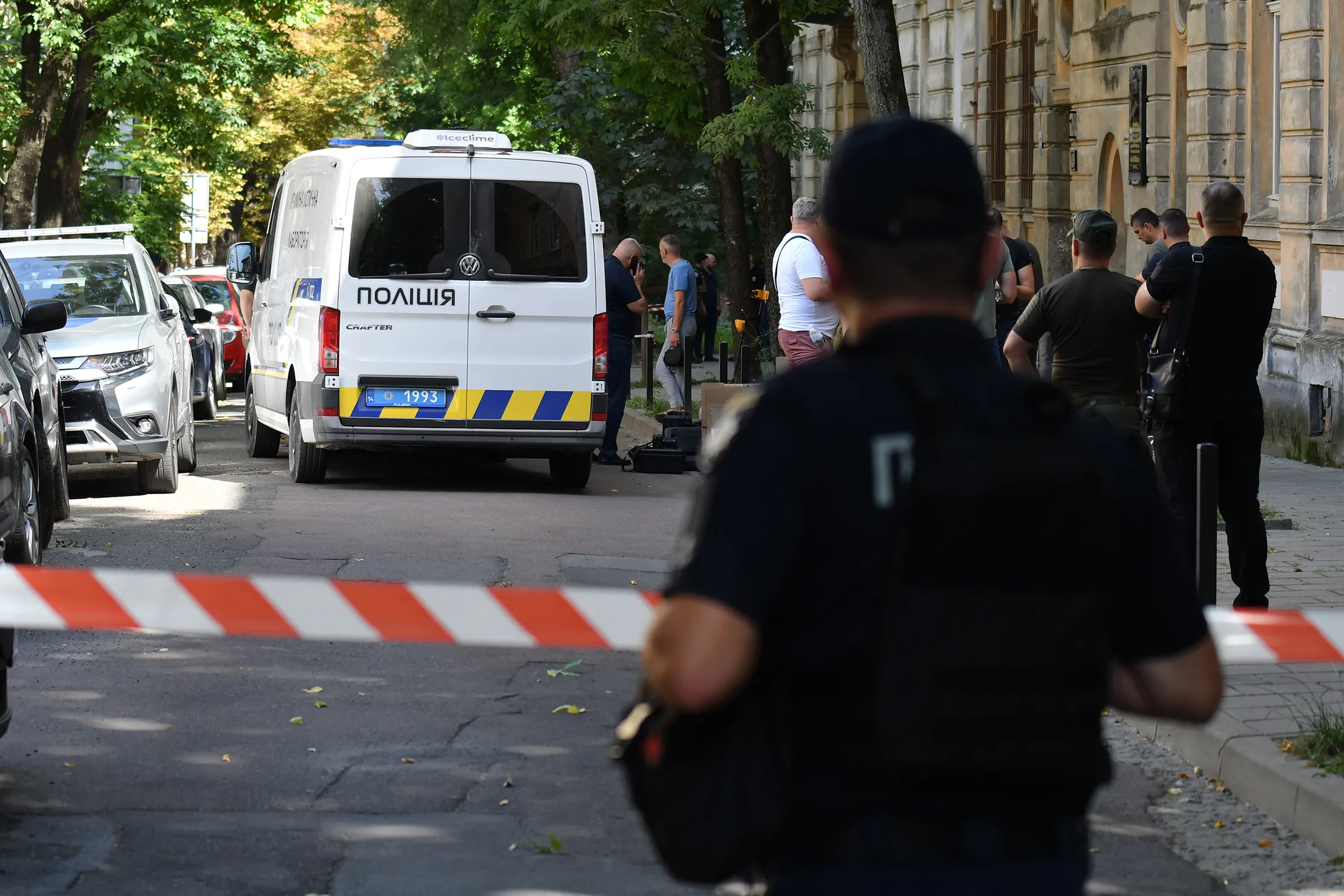 Law enforcement officers work at the site of the shooting of Andriy Parubiy in Lviv, Ukraine, on Aug. 30.