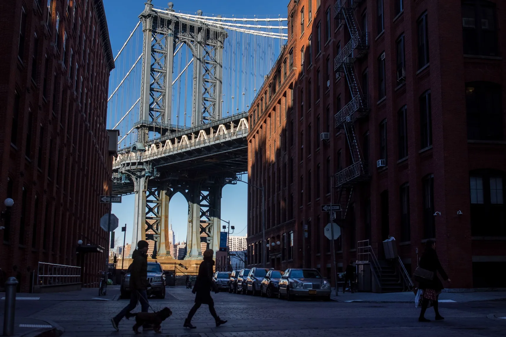 Pedestrians cross a street in the DUMBO neighborhood of Brooklyn.