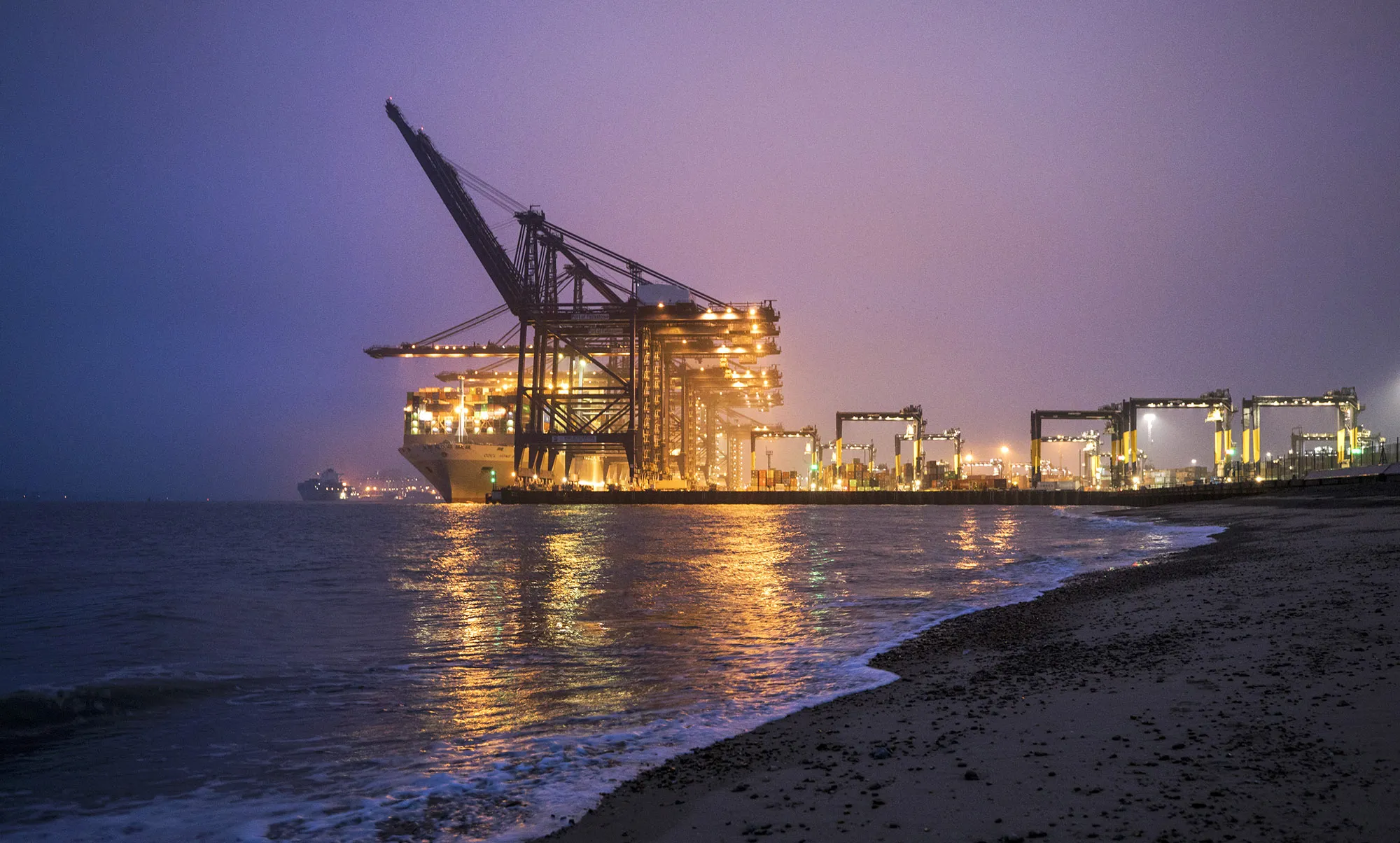 A container ship sits anchored dockside at the Port of Felixstowe in Felixstowe, U.K.