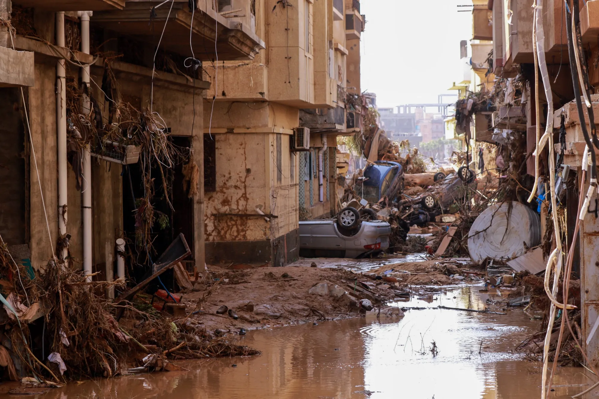 Overturned cars lay among other debris in Derna, eastern Libya.