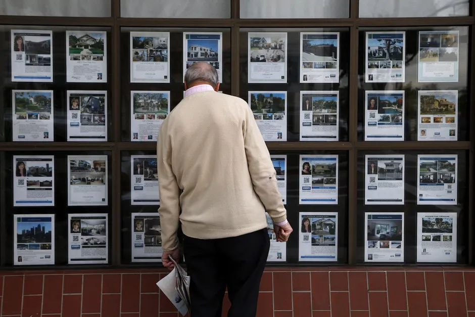 A man looks at listings of homes for sale in Los Angeles.