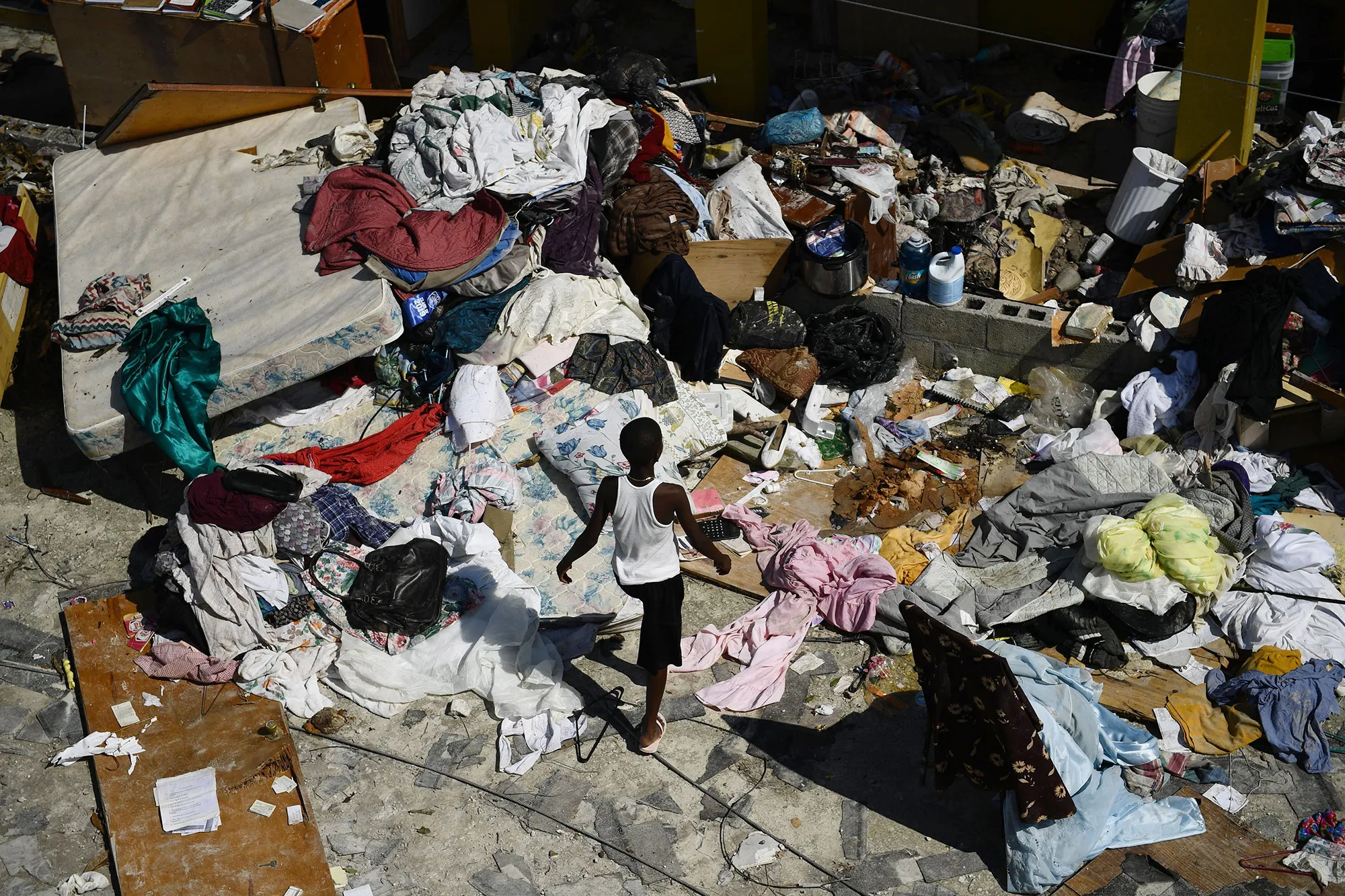 A boys walks through debris in Marsh Harbour, Bahamas, on Sept. 7, 2019.