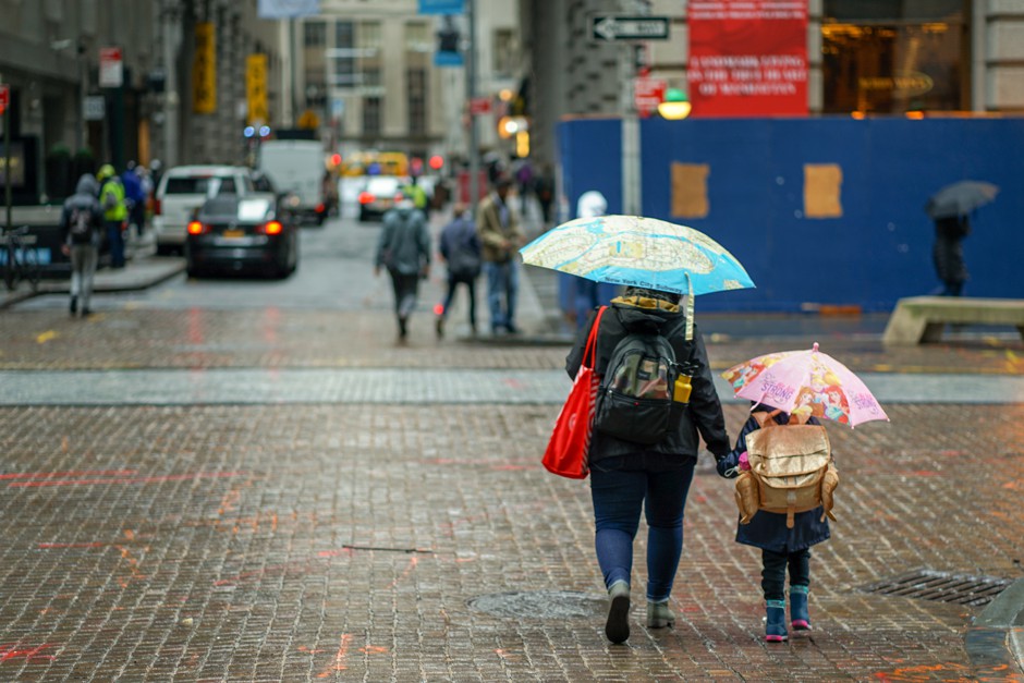A woman and a child walk in New York, the city with the highest score for walkability given at walkscore.com. A new study finds that growing up in a walkable neighborhood can increase upward economic mobility for children.