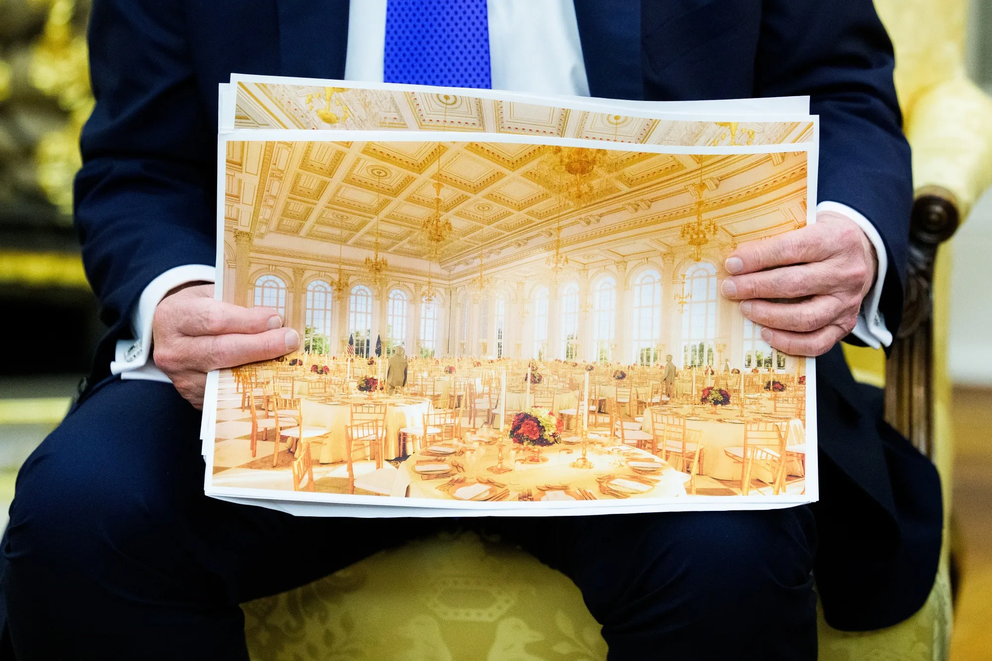 President Donald Trump holds a rendering of the proposed White House ballroom in the Oval Office on Oct. 22.