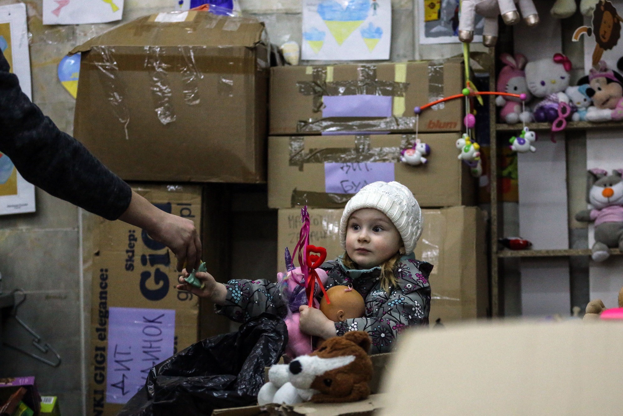 This is a perilous time for the world. Above: A toy&nbsp;is given&nbsp;to a displaced Ukrainian child at an&nbsp;aid center in Lviv.