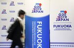 A man walks past banners for the Group of 20 (G-20) finance ministers and central bank governors meeting outside the media center of the meeting in Fukuoka, Japan.