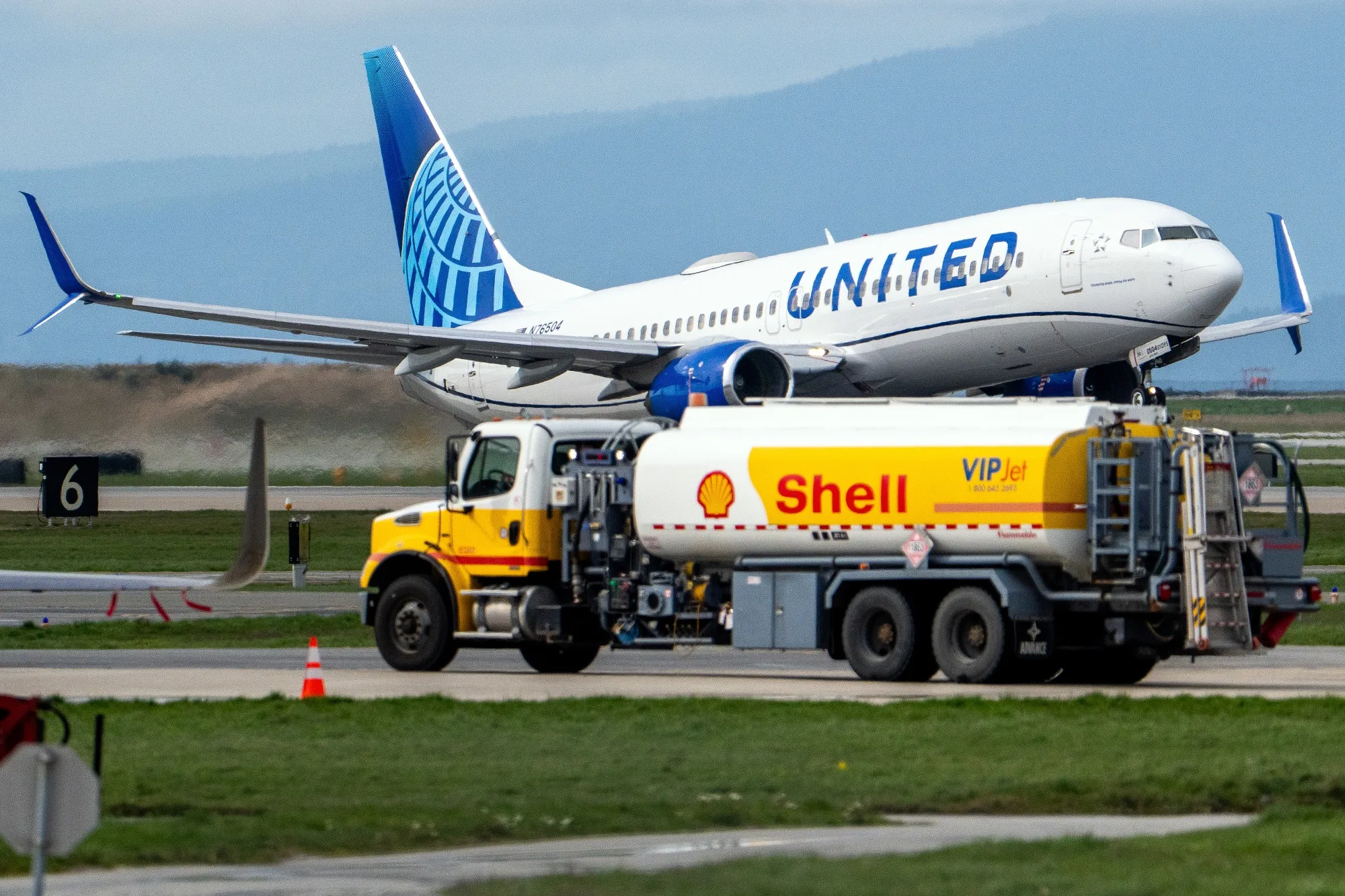 A United Airlines airplane passes a Shell jet fuel truck at Vancouver International Airport in Richmond, British Columbia, Canada.