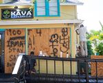 Employees of the Island Root Kava Lounge board up the windows of the business in preparation for Hurricane Dorian in Melbourne, Florida, U.S.