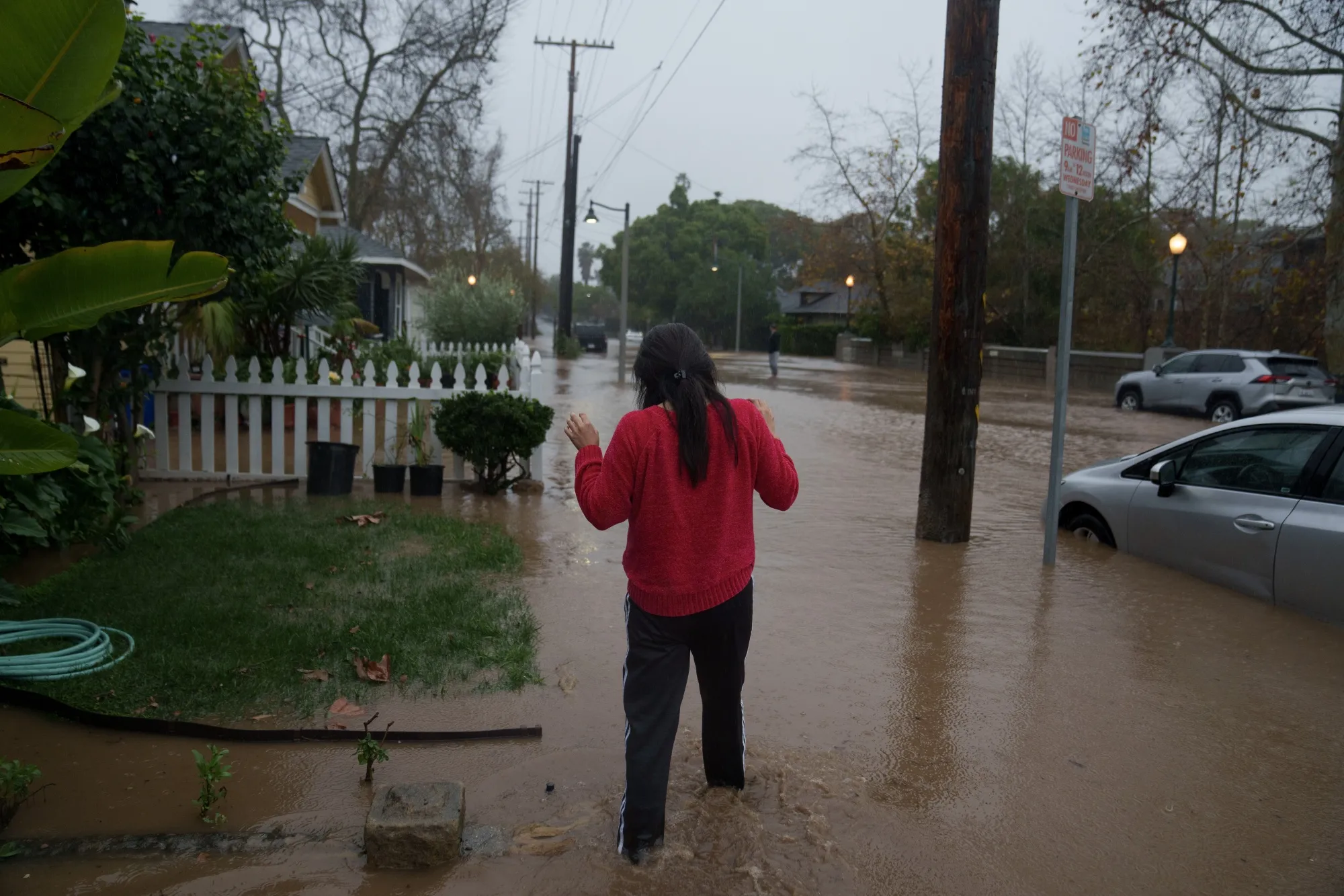 A woman walks through floodwater during a storm in Santa Barbara, California on Feb. 4.