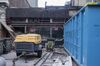 Lenox Lounge location being demolished with trash container and heavy equipment in front