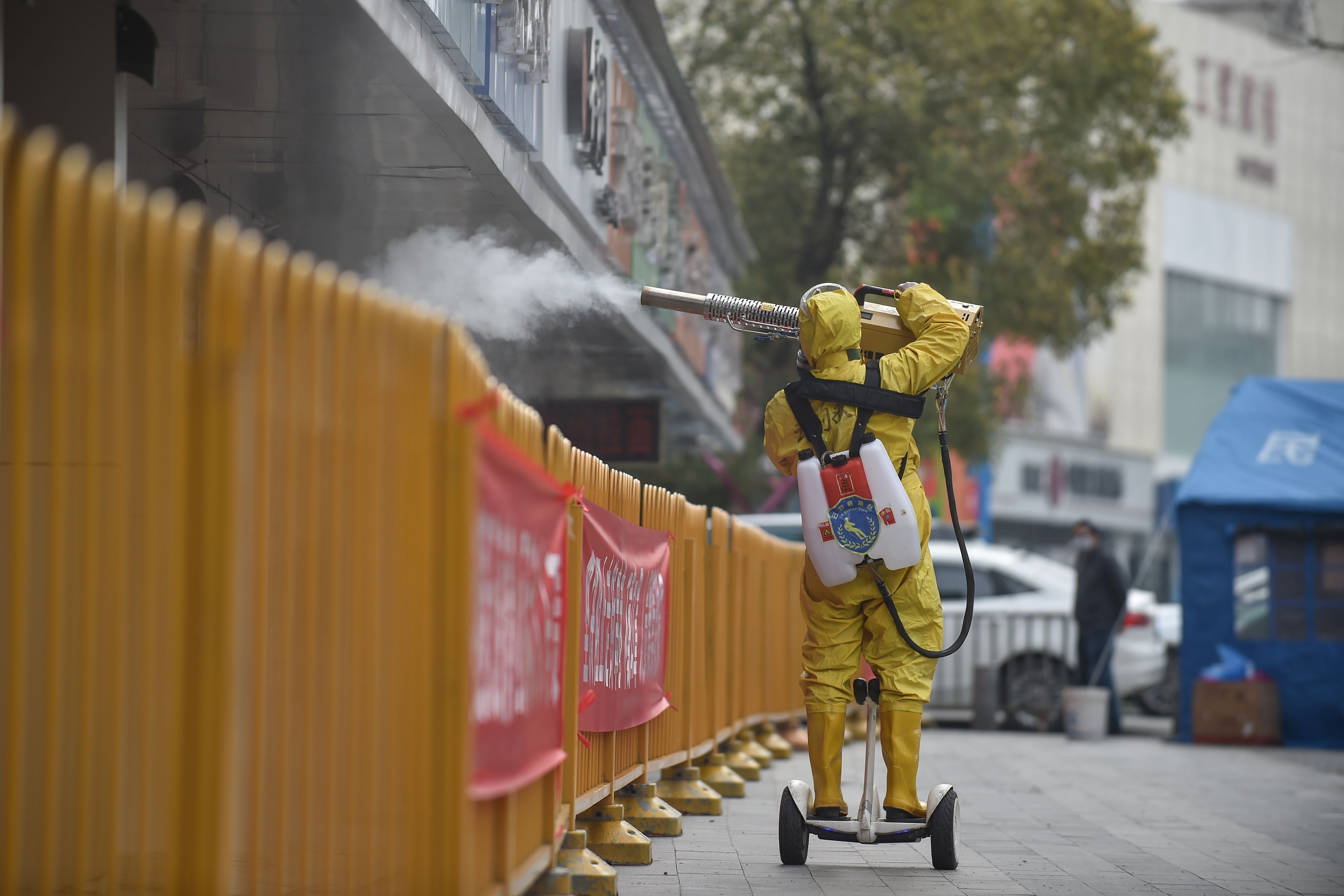 A medical staff member sprays disinfectant at a residential area in Wuhan on March 11.