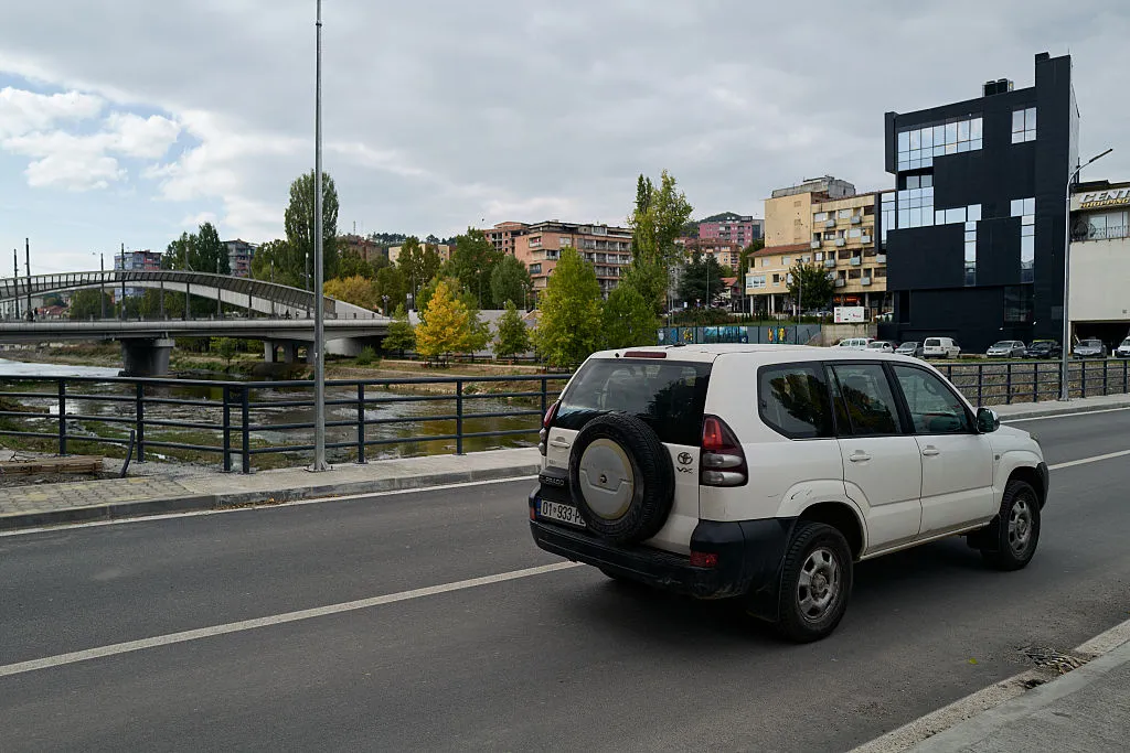 A vehicle crosses a new bridge connecting South and North Mitrovica.