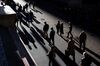 Pedestrians walk along Wall Street near the New York Stock Exchange (NYSE) in New York, U.S.