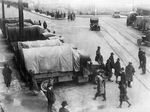 Striking workers walk by covered trucks during the 1919 General Strike.