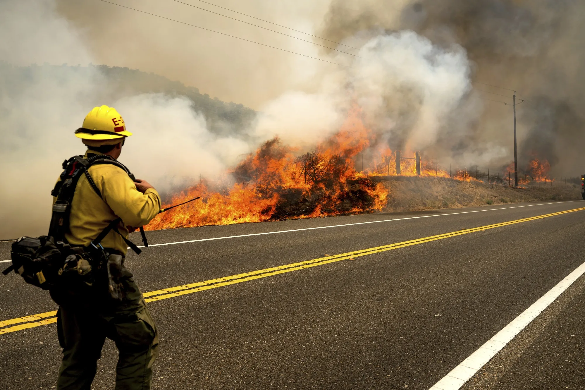A firefighter battles the Madre Fire&nbsp;along Highway 166&nbsp;in San Luis Obispo County, California,&nbsp;on July 3.