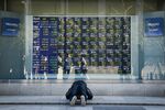 A man reacts after looking at an electronic stock board outside a securities firm in Tokyo, Japan.