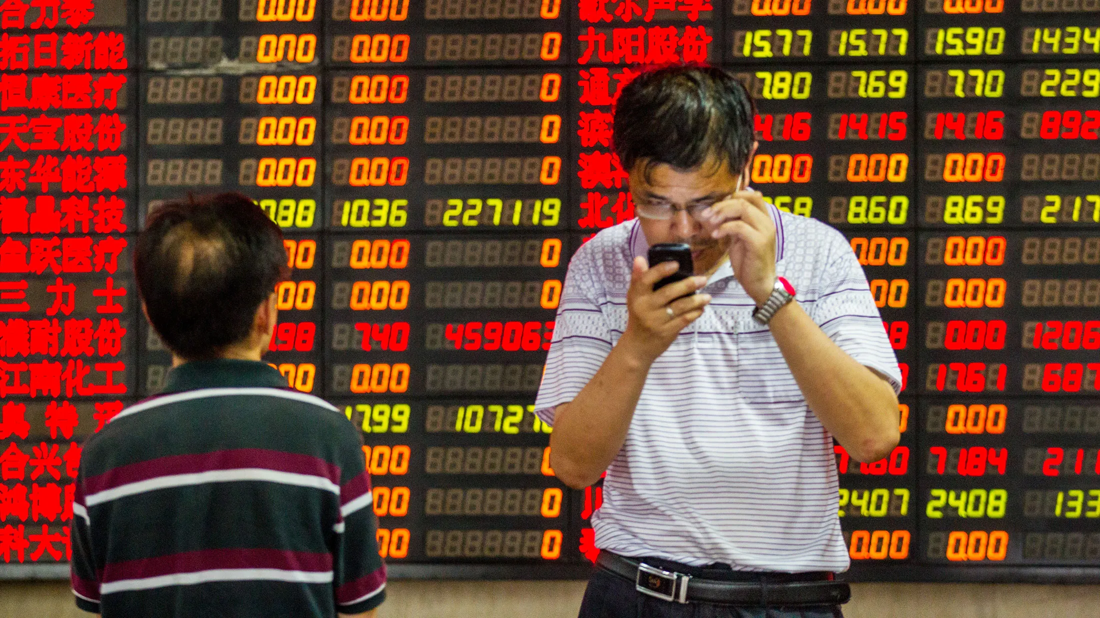 Investors observe stock market at a stock exchange hall in Shanghai, China.
