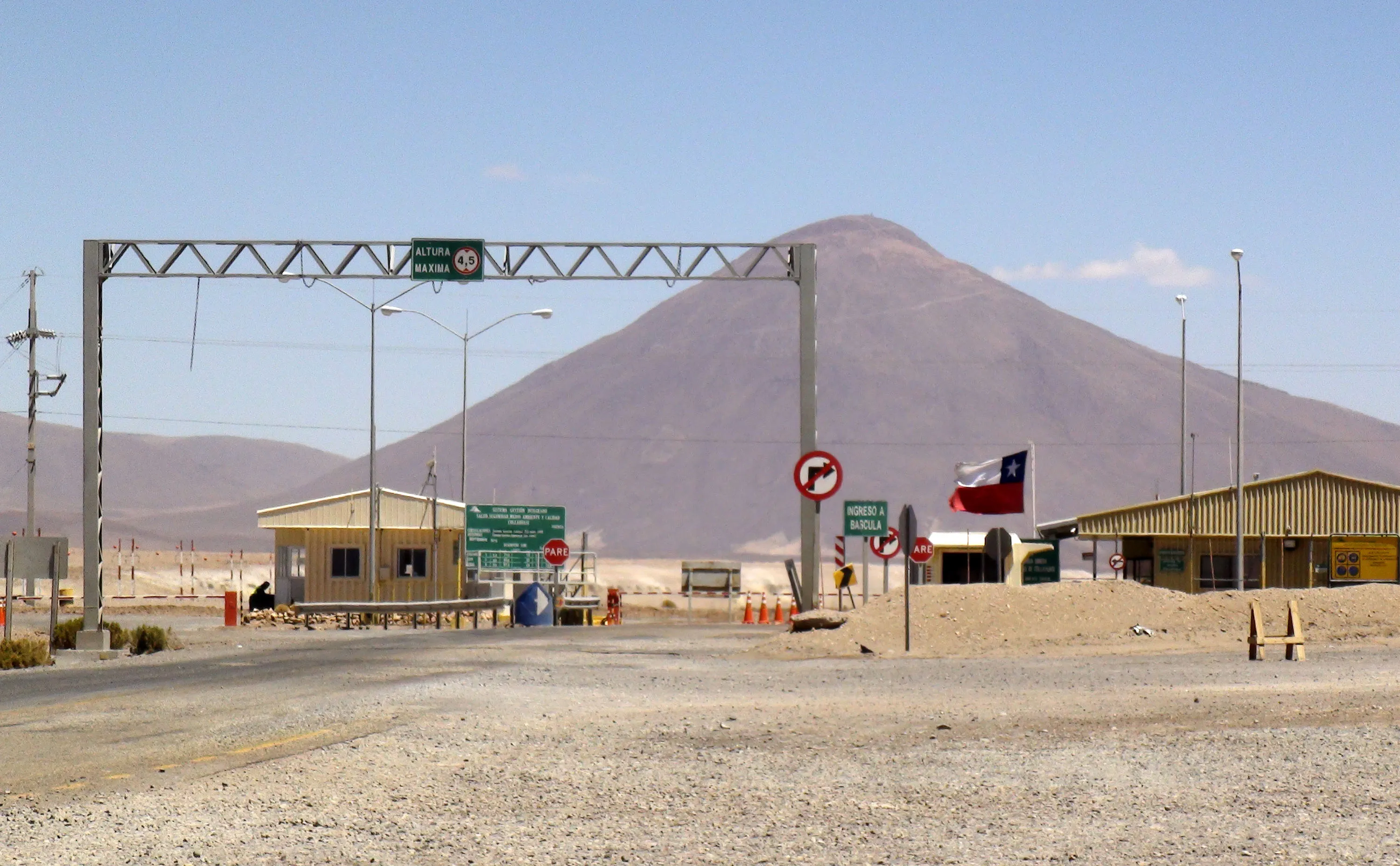 Signage stands at the entrance to the Collahuasi mine on the northern coast of Chile, on Sunday, Nov. 7, 2010. Anglo American Plc and Xstrata Plc kept their Collahuasi venture operating normally as a strike by unionized workers at the world's fourth-largest copper mine entered a fourth day, a Collahuasi spokeswoman said. Photographer: Bloomberg/Bloomberg
