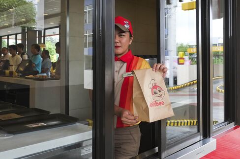 Jollibee CEO Ernesto Tanmantiong And Customers Inside A Jollibee Restaurant