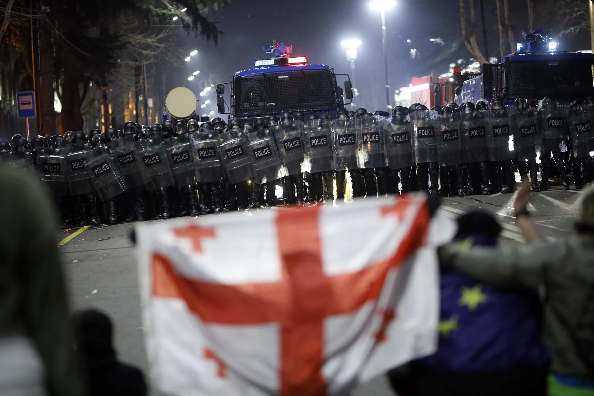Riot police face protesters in Tblisi on March 8.