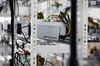 Cables are attached to an application-specific integrated circuit (ASIC) device and power unit, manufactured by Bitmain Technologies Inc..