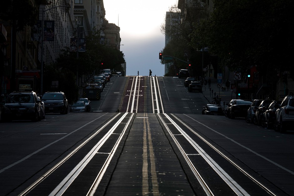 Pedestrians cross an empty California Street in San Francisco after residents were told to shelter in place.