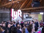 People celebrate during Lyft’s initial public offering at the company's new service center in Los Angeles.