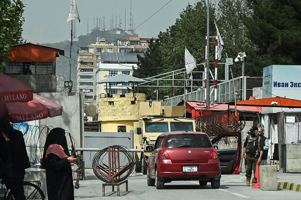 A Taliban security guard inspects a vehicle at the entrance of the Embassy of Russia in Kabul, on April 17.