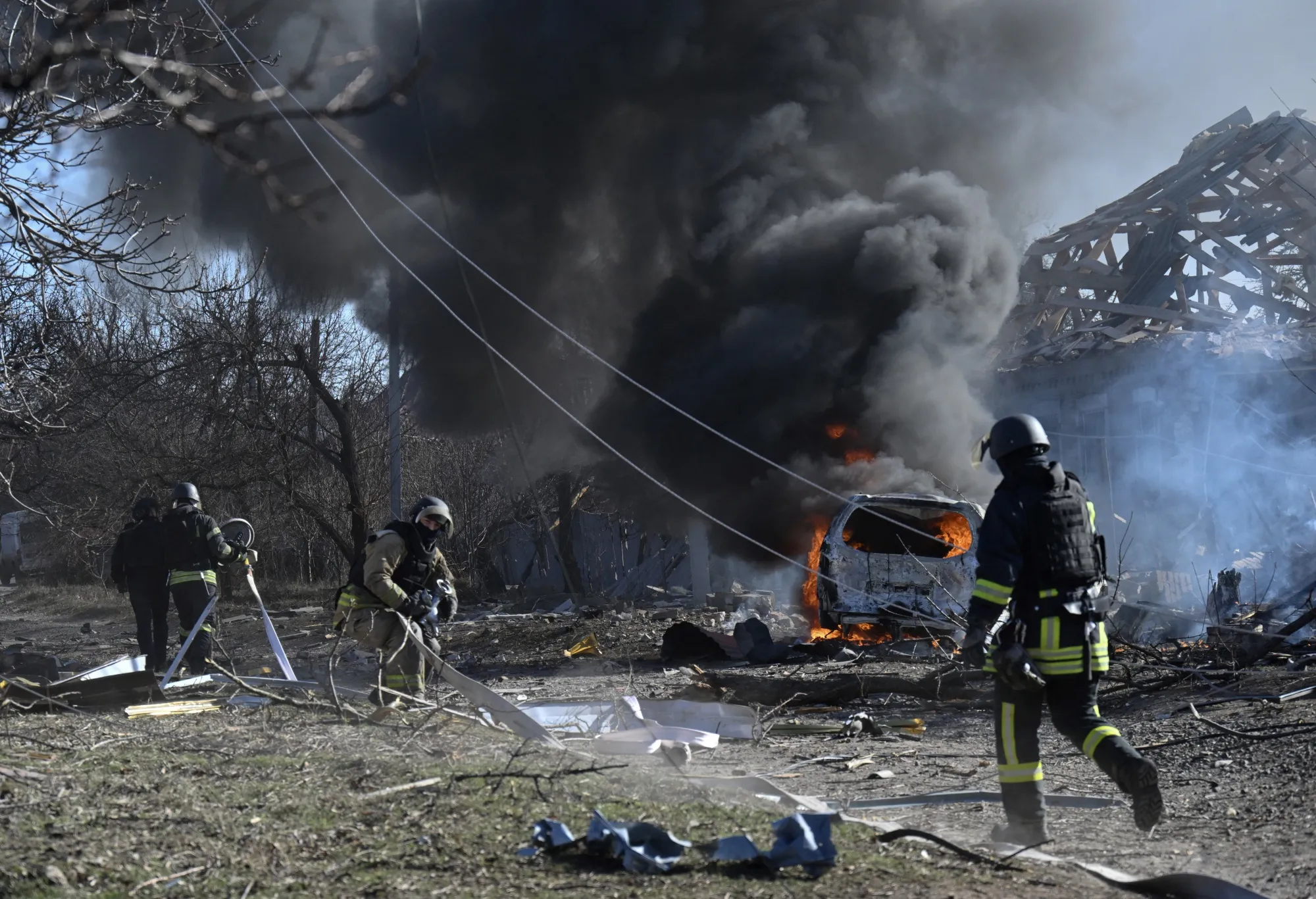 Ukrainian firefighters work at the site of a strike in Kramatorsk, Ukraine, on Feb. 13.