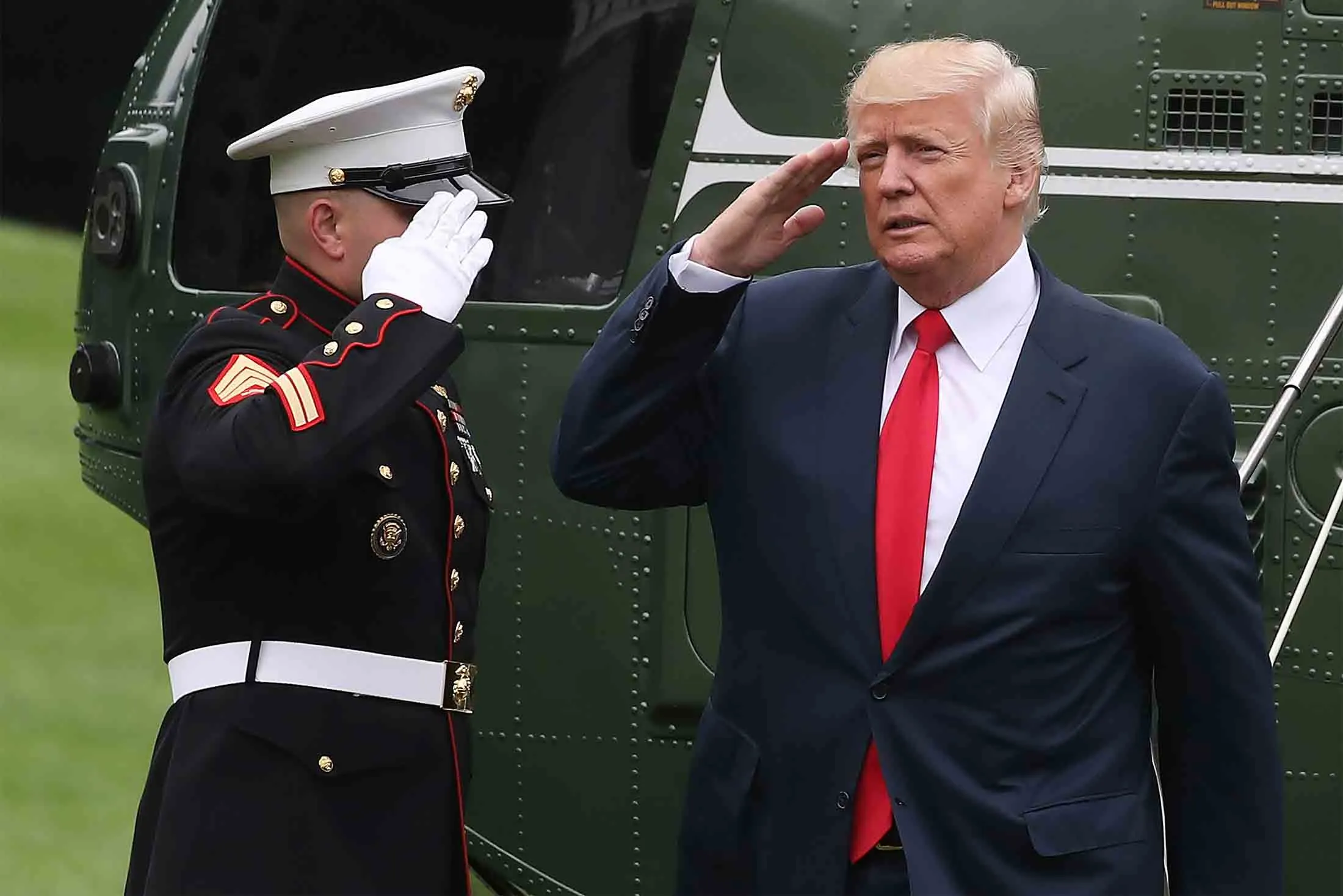 President Donald Trump salutes a U.S. Marine after landing on the South Lawn at the White House on August 14, 2017.