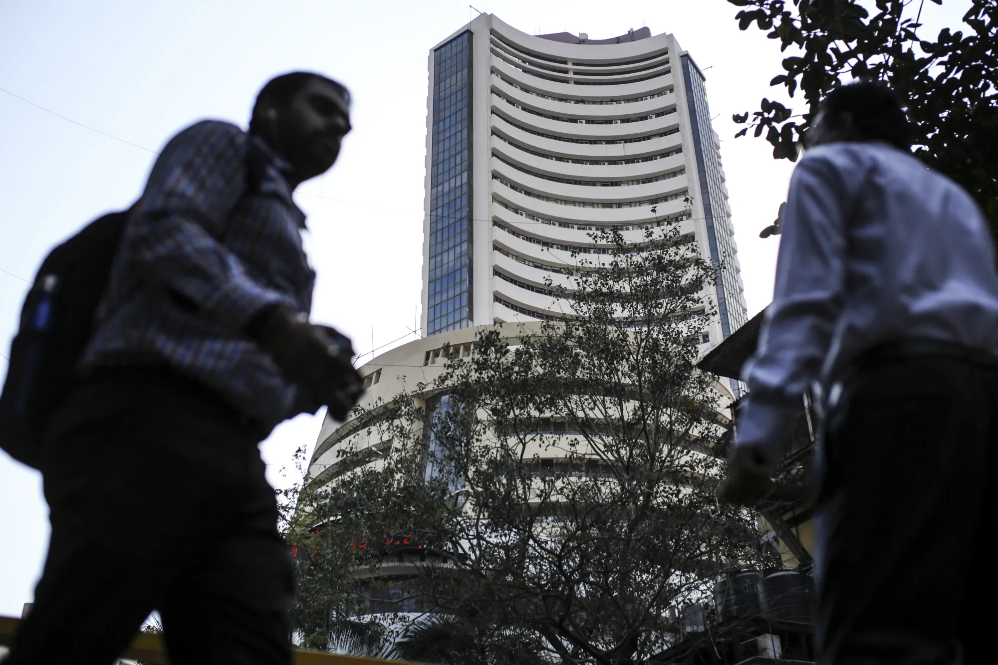 Pedestrians walk past the Bombay Stock Exchange (BSE) building in Mumbai.
