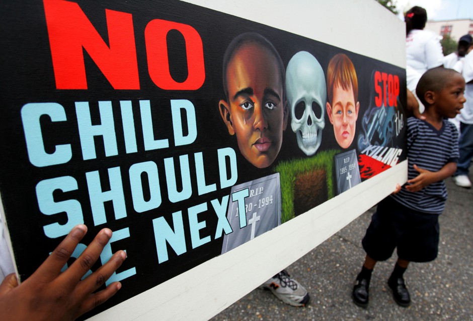Kentrel Smith, 4, carries a sign protesting the violence in New Orleans.