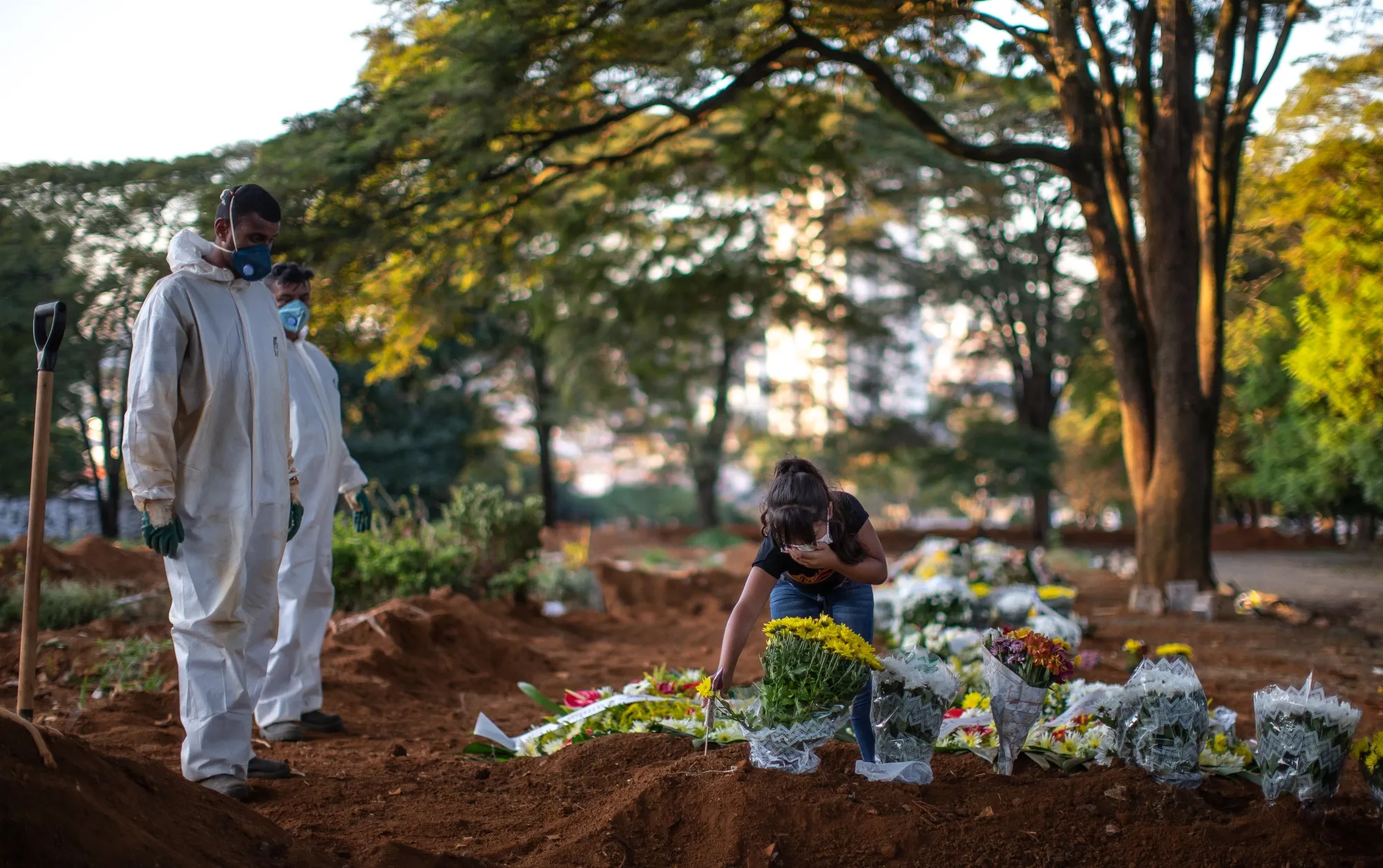 A family member mourns at the grave of a Covid-19 victim at the Vila Formosa cemetery in Sao Paulo, Brazil on April 29, 2020.