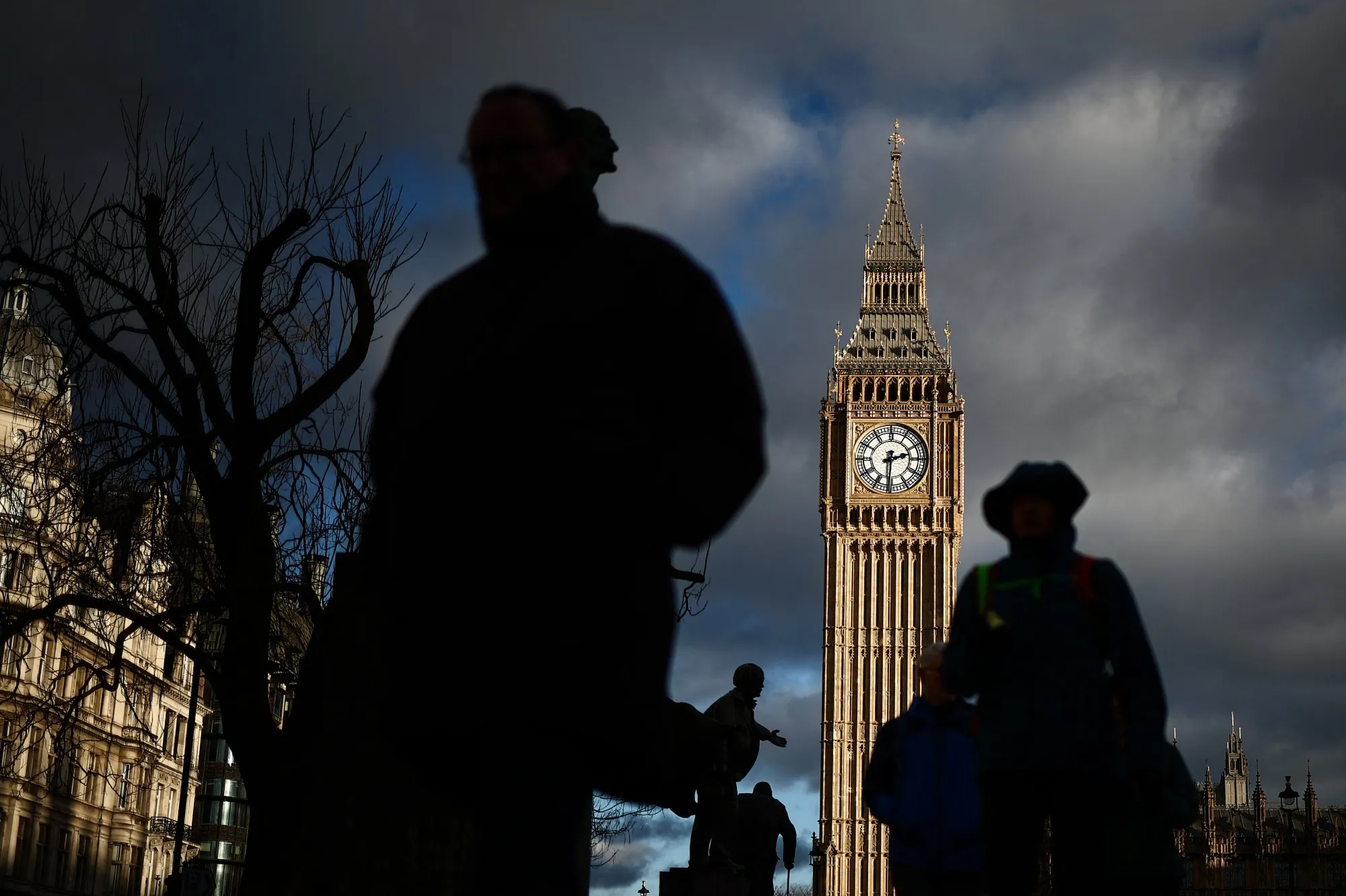 Pedestrians walk past the&nbsp;Houses of Parliament&nbsp;in London.