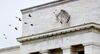 Birds fly past the Marriner S. Eccles Federal Reserve Board Building in Washington, D.C.