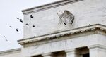 Birds fly past the Marriner S. Eccles Federal Reserve Board Building in Washington, D.C.
