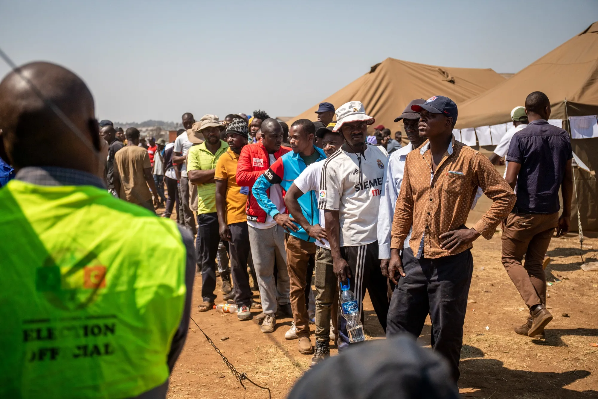 Voters wait in line to cast their ballot in Harare on Aug. 23.