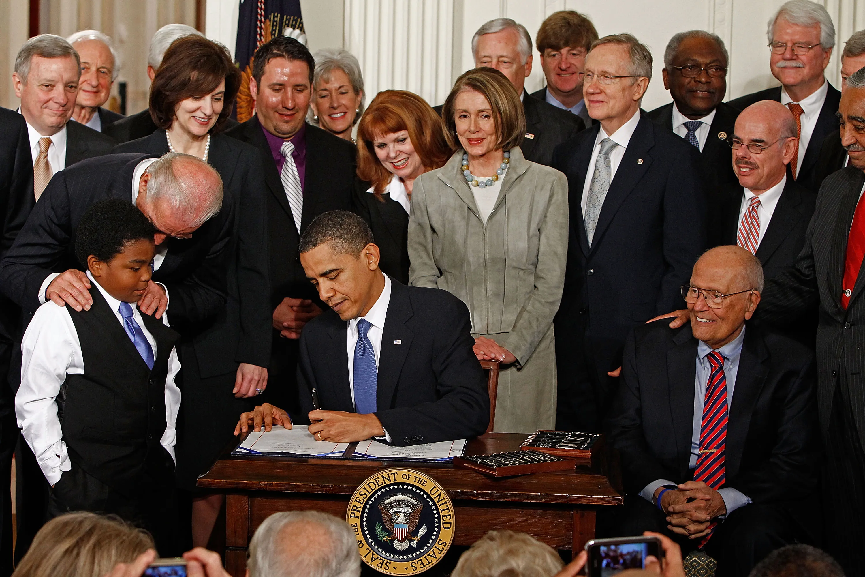 President Barack Obama signs the Affordable Health Care for America Act during a ceremony with fellow Democrats in the East Room of the White House March 23, 2010 in Washington, DC. The landmark bill was passed by the House of Representatives Sunday after a 14-month-long political battle that left the legislation without a single Republican vote.
