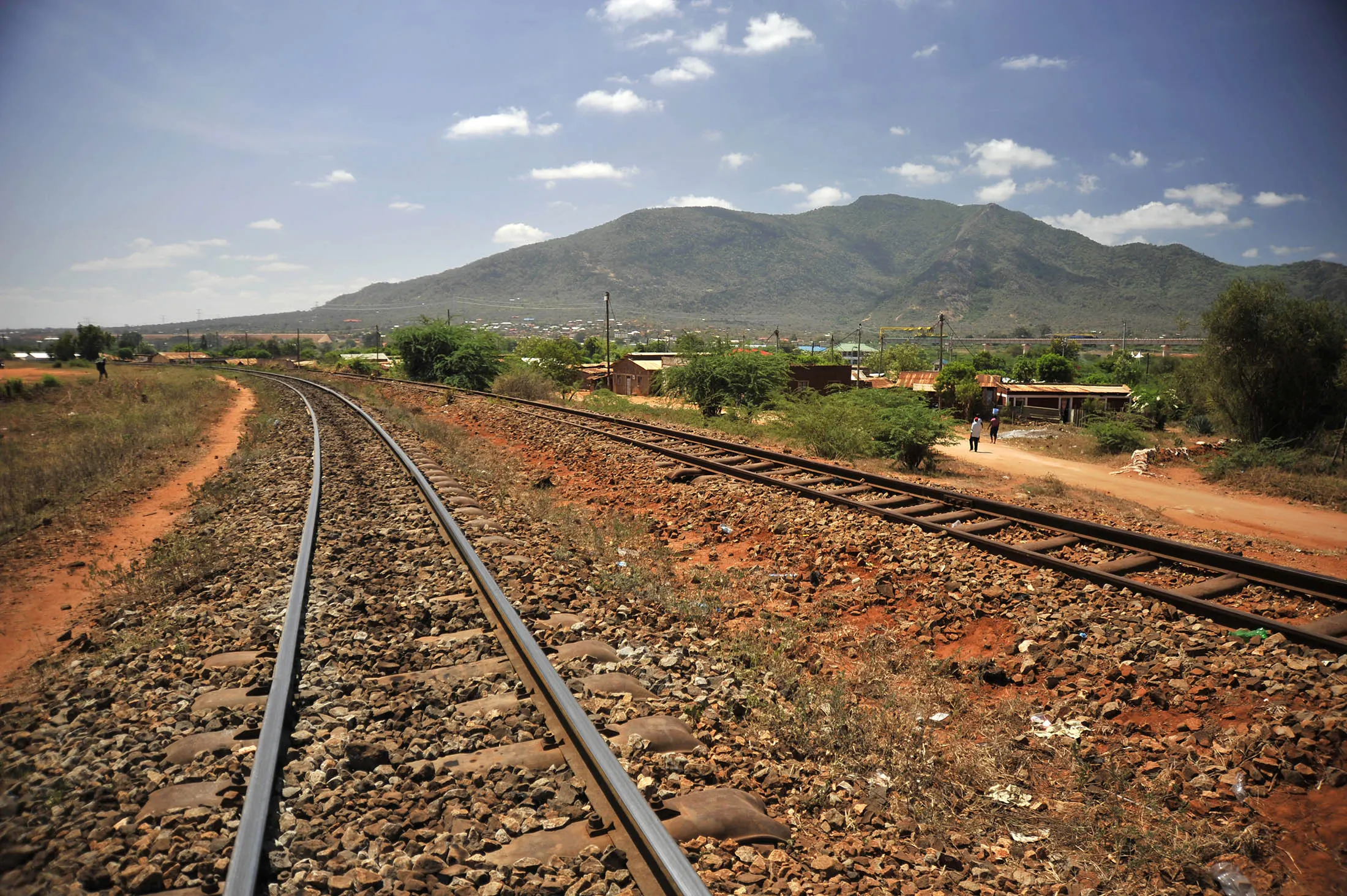 An old colonial-era railway line sits near the site of the new Mombasa-Nairobi Standard Gauge Railway line under construction in Voi, Kenya.
