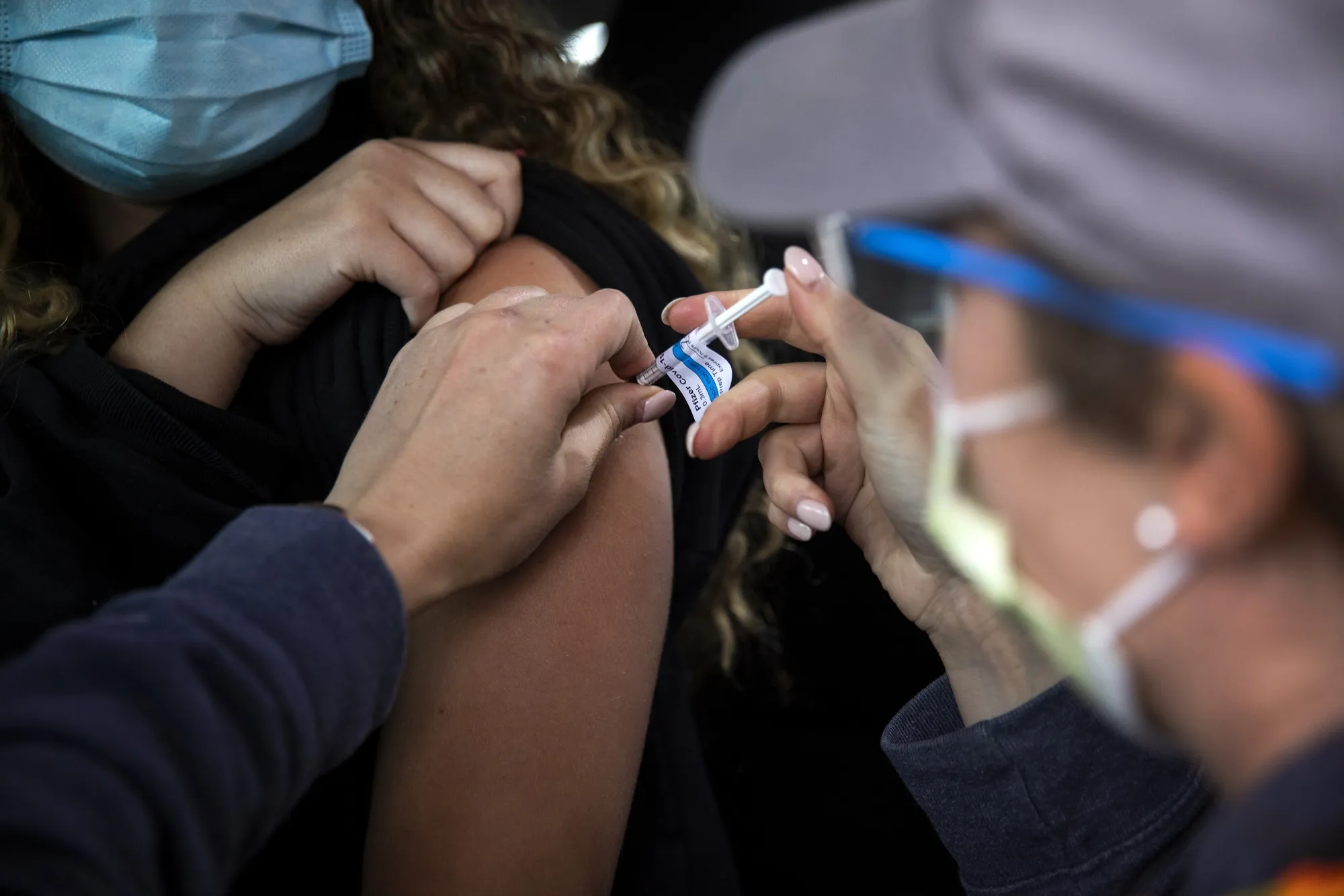 Healthcare Workers Administer Covid-19 Vaccines At Airport As U.S. Daily Cases Hit 14-Month Low