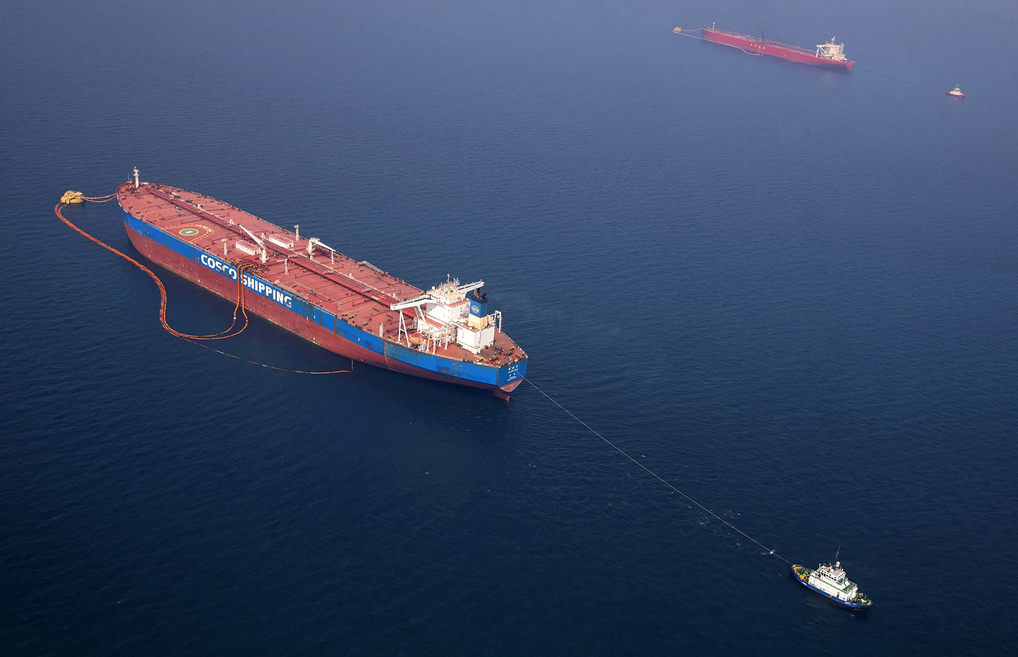 Pipes feed crude oil to a tanker, near the Ras Tanura oil refinery, Saudi Arabia.