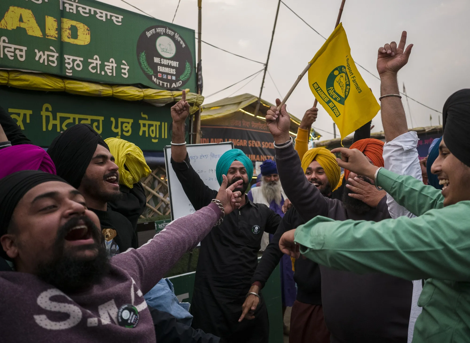 Farmers celebrate at the Delhi-Haryana border crossing in Singhu, Delhi, India, on Nov. 19.