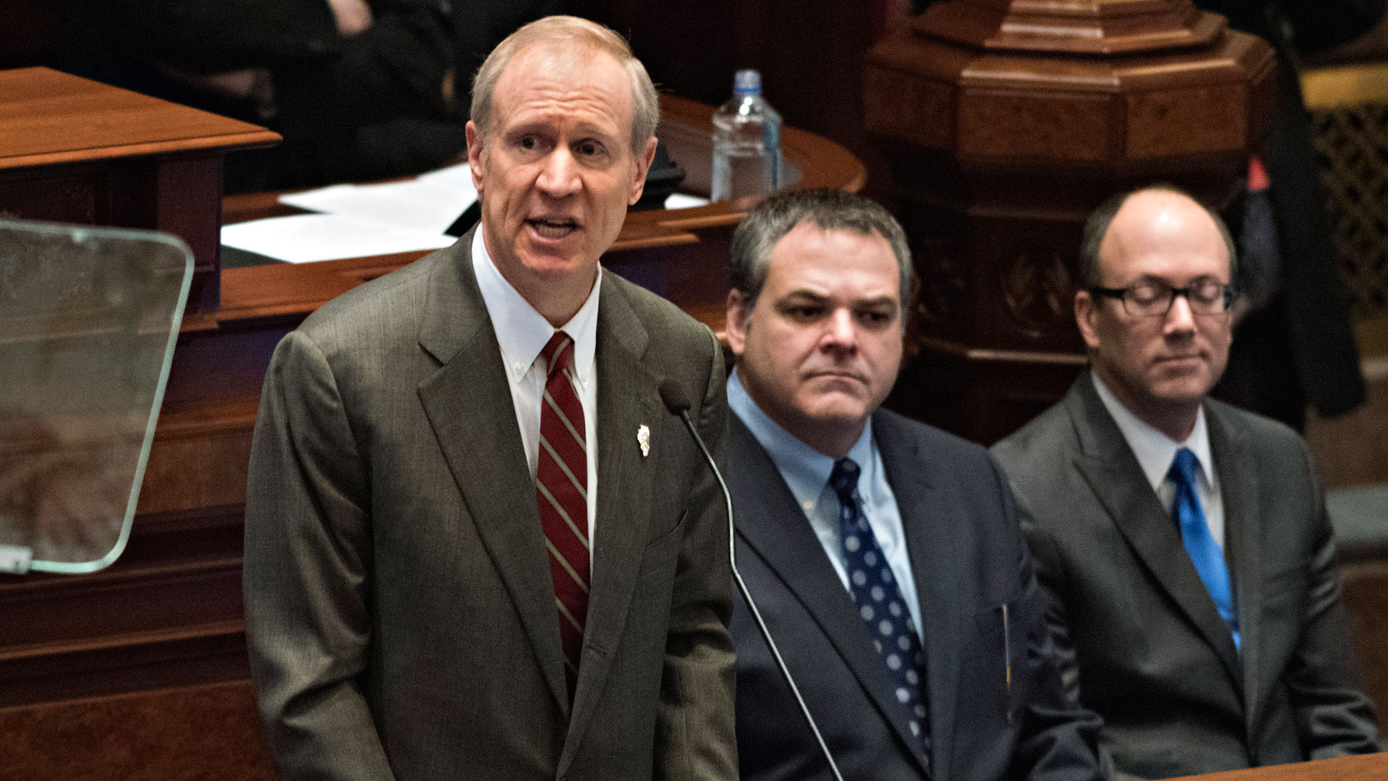 Bruce Rauner, governor of Illinois, left, delivers a budget address in the House Chamber of the State Capitol building in Springfield, Illinois, U.S., on Wednesday, Feb. 18, 2015.
