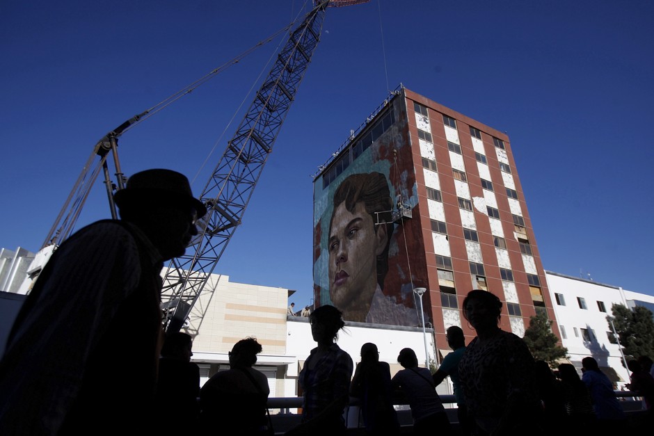 People walk past a new 40-square meters mural of Mexican singer Alberto Aguilera Valadez, better known as Juan Gabriel, in downtown Ciudad Juarez.