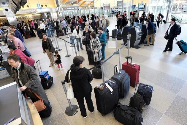 Passengers wait in long lines at the Raleigh-Durham International Airport