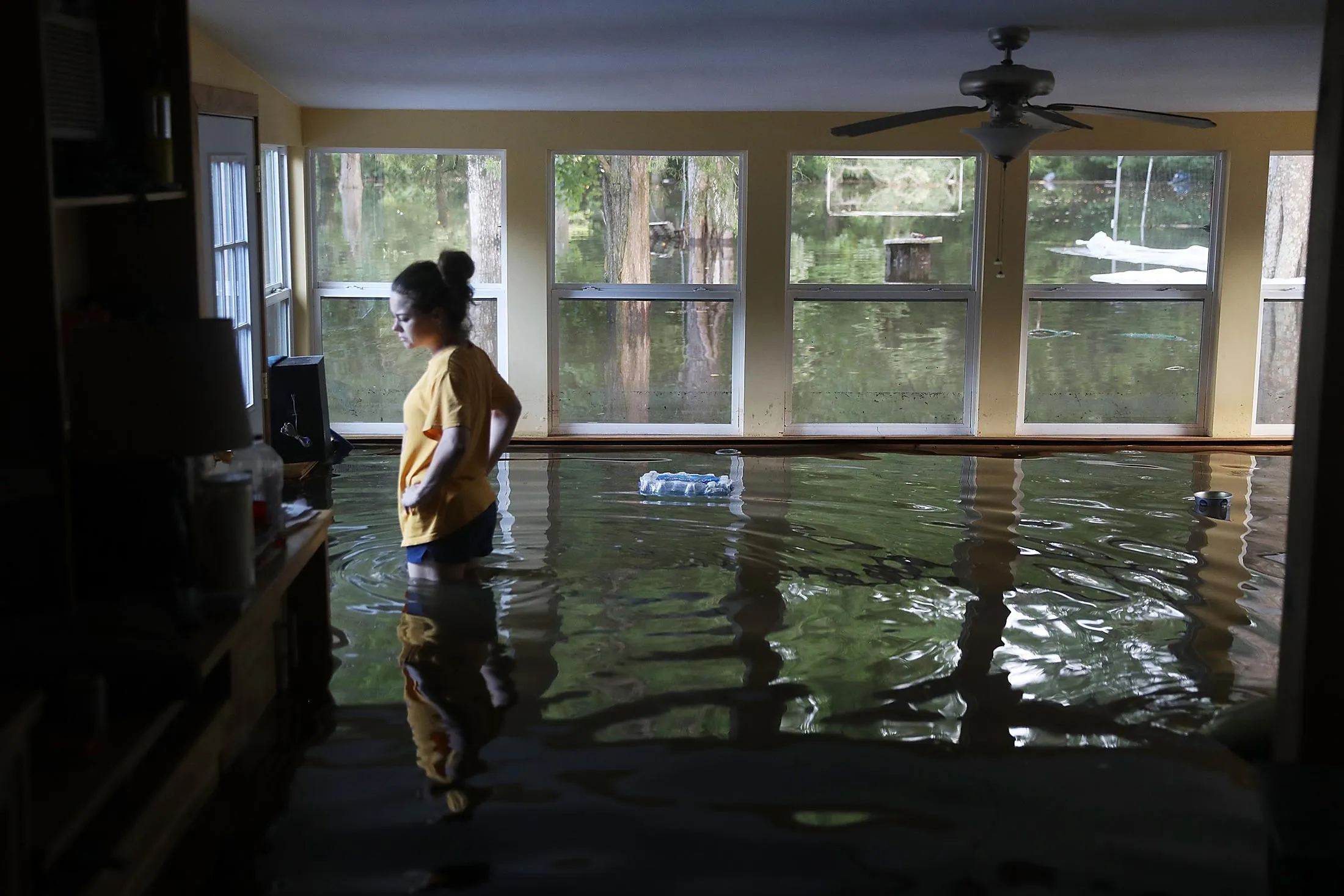 A woman surveys the flood damage to her home on Aug. 17, 2016 in Sorrento, Louisiana.
