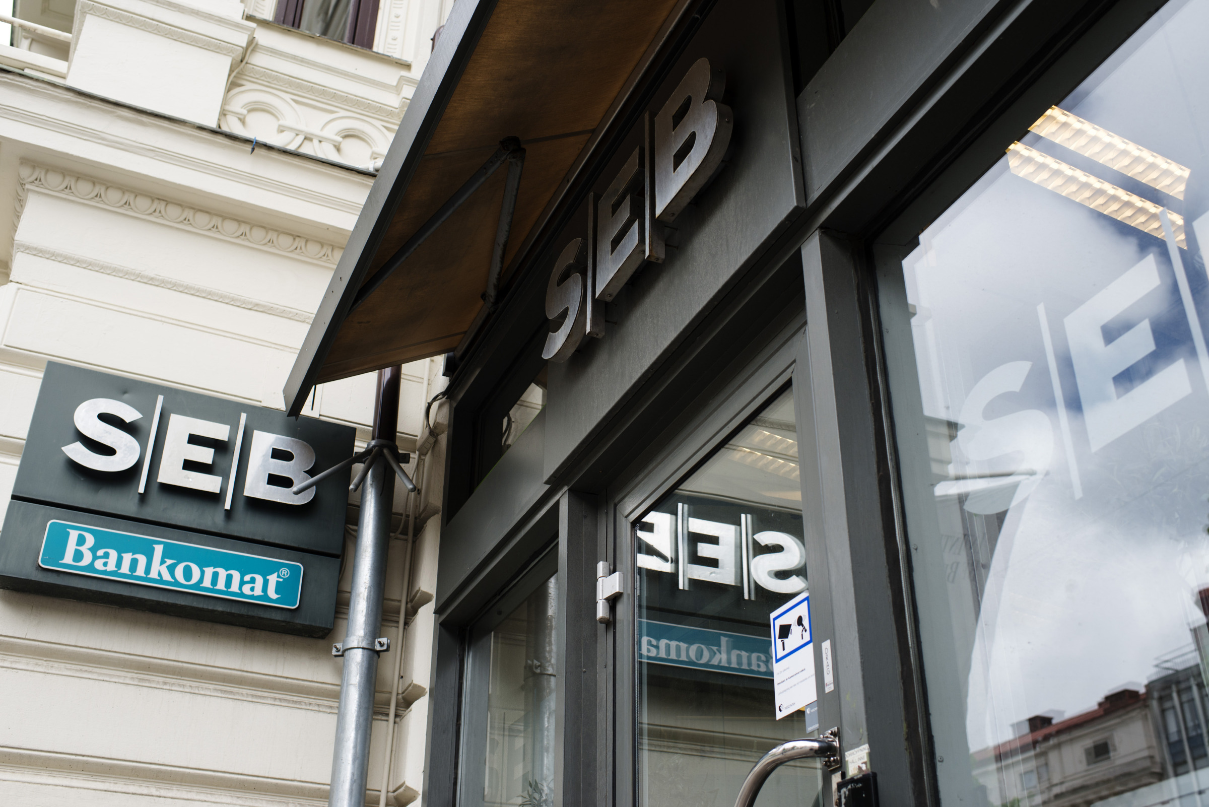 Logos sit on display outside an SEB AB bank branch&nbsp;in Gothenburg.